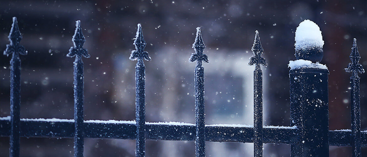 Ornamental fencing covered in snow.